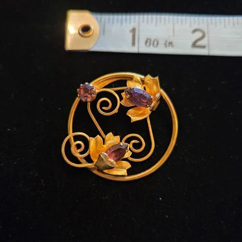 Vintage Gold Tone Floral Circle Brooch Featuring 3 purple rhinestones